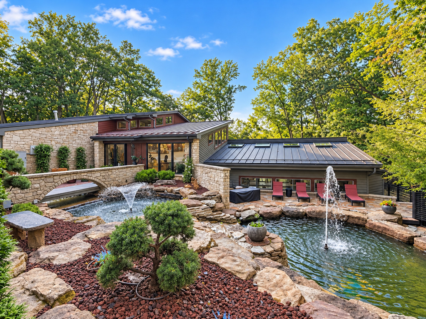 After: completed luxury courtyard with landscaped stone ponds, two fountains, bridge and terrace
